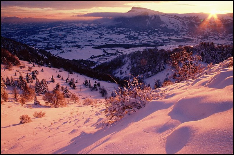 Photo : Gapençais : dans un petit vallon sauvage sur l'envers de la montagne de Charance, soleil couchant sur la neige fraîche.Il s'agit de la dernière chute de neige de l'année 2004, et pour le moment, la dernière en date..on attendra la suivante pour retrouver des arbres chargés de blanc. 
